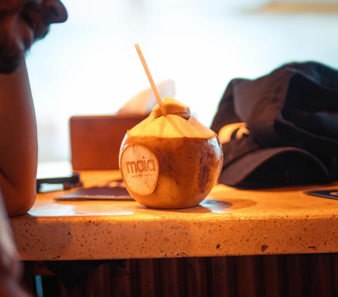 A branded 'maia' fresh coconut on the terrazzo bar top