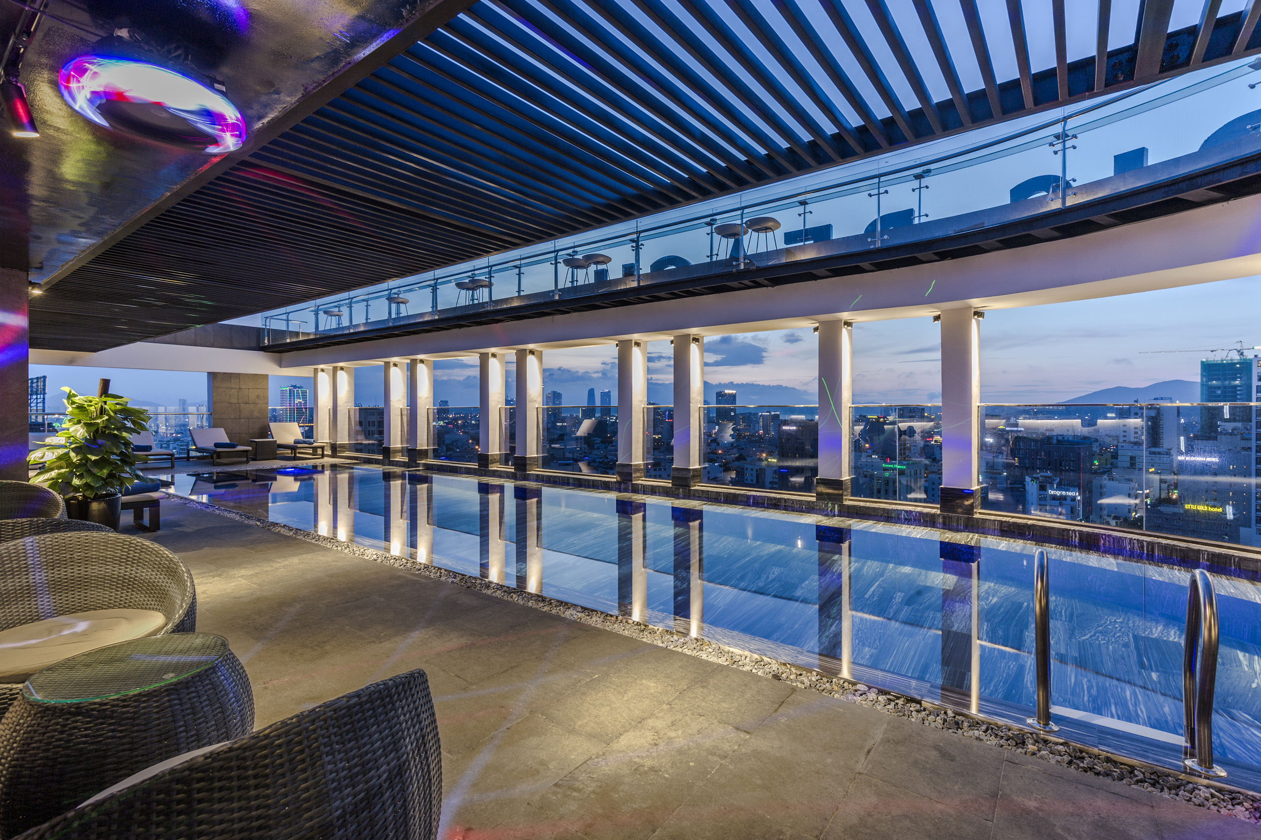 Rooftop pool at blue hour overlooking the city and Son Tra Peninsula