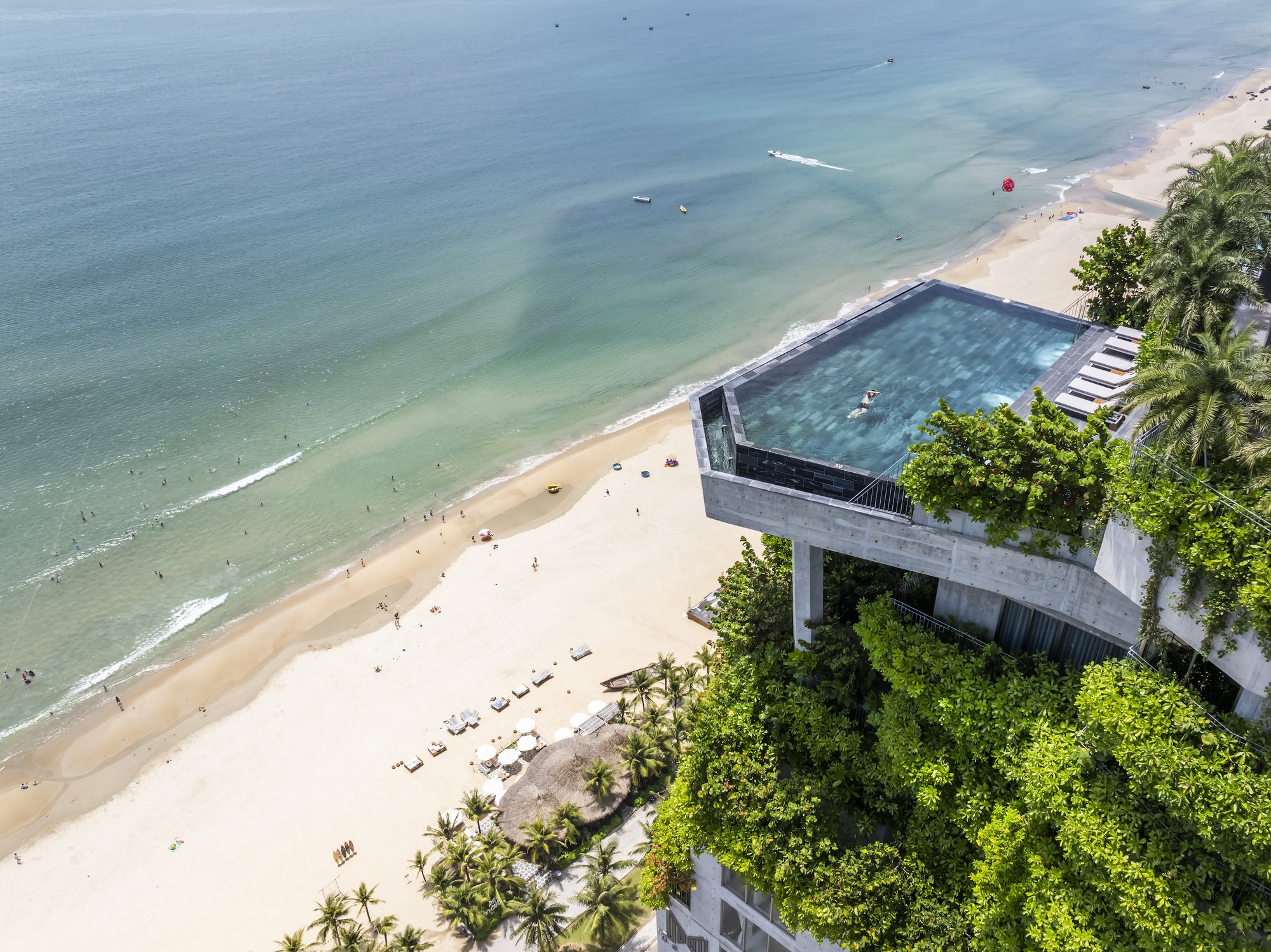 Aerial of the rooftop infinity pool above the beach and ocean