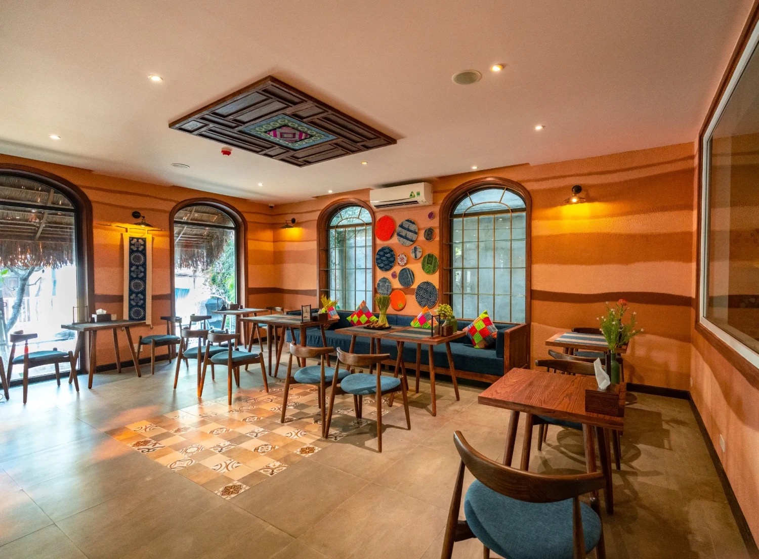 A tiled tea-and-seating area with ethnic decor at Luxury Herbal Spa