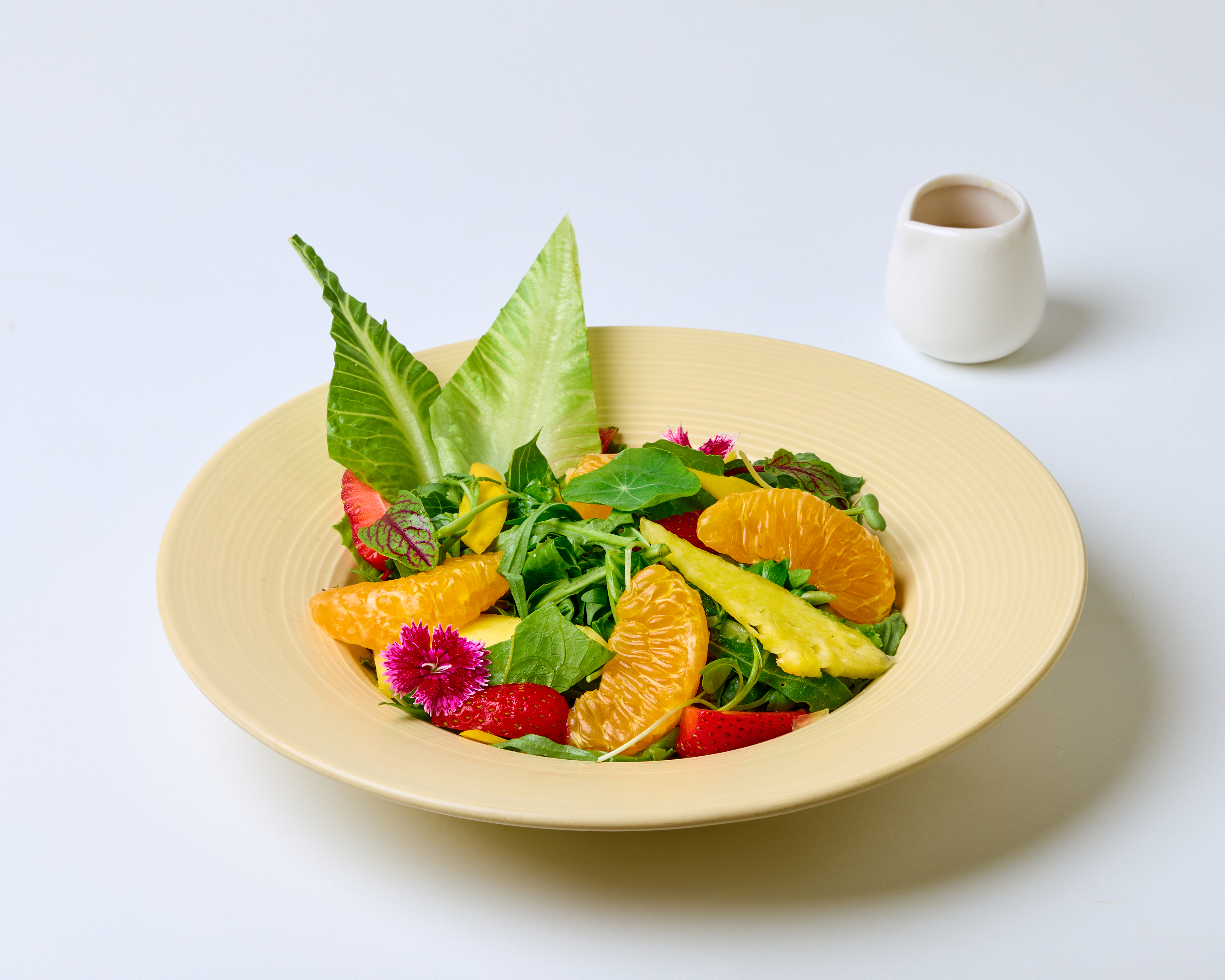 A colorful fresh-fruit and greens salad plate at Voi's Kitchen